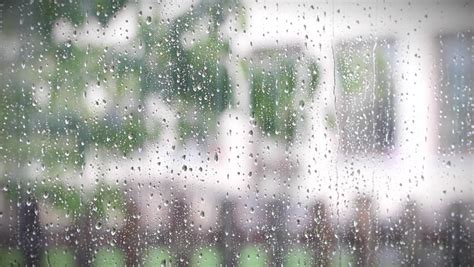 Heavy Rain Falling Against Large Window Pane Raindrops Trickle Down