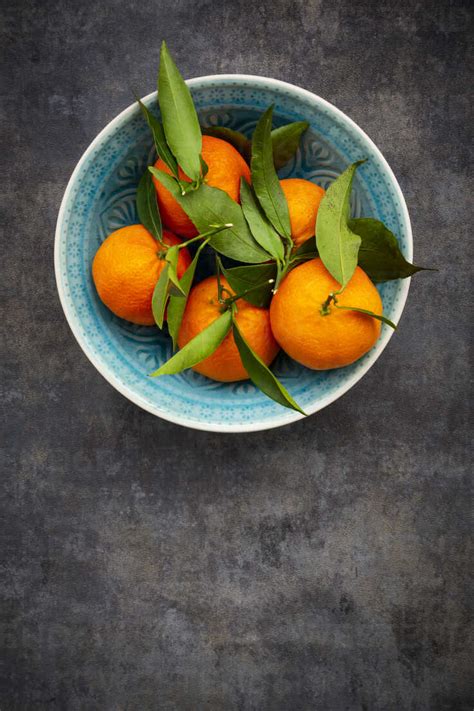 Clementines In Bowl From Above Stock Photo