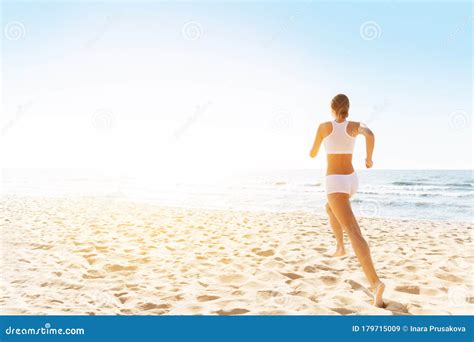 Woman Running On Sunny Sea Beach Rear Back View Jogging Girl In White