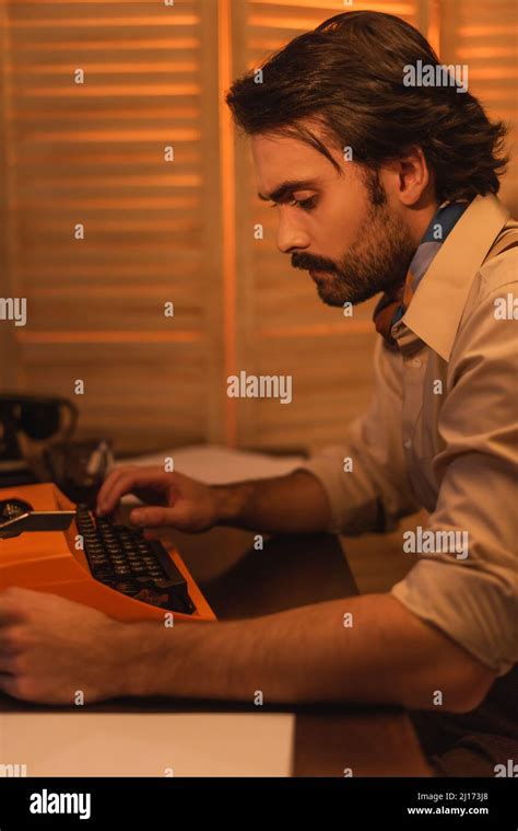 Side View Of Writer Using Typewriter Machine Stock Photo Alamy