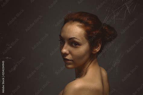 sexy nude lady look mysterious and posing on a camera hair collected in a bun art vintage