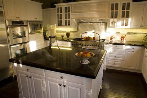 Dark brown cabinets bring out the white of the countertops and create a very put together look for the kitchen. How Much Is the Average Price of Granite Countertops ...