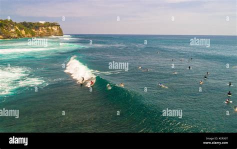 Unidentified surfers at Suluban surf beach. Jimbaran, Bali, Indonesia