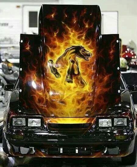 A Car With Flames Painted On Its Hood