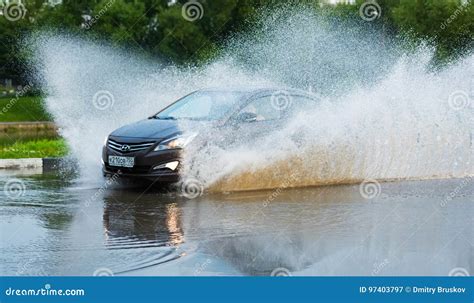 car rain puddle splashing water editorial photography image of automobile driving 97403797