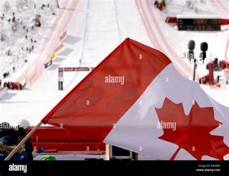 A Canadian Flag Is Waved In The Finish Area During The Mens Downhill