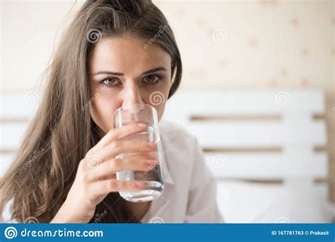 Woman Drinking Fresh Water In The Bed At The Morning Stock Image