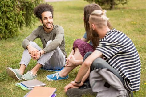 College Students Sitting And Talking On Lawn Stock Image Image Of
