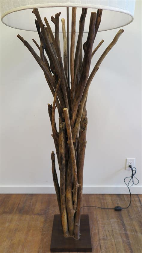 Mounted on a copper base with a patina finish, the lamp stands approximately 50 inches high. Natural Twig Driftwood Floor Lamp For Sale at 1stdibs