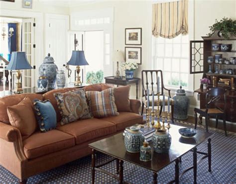 Chic seating area with a brown sofa and a navy accent wall and textiles. 17 Pleasant Blue and Brown Living Room Designs