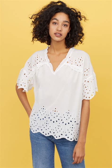 white blouse in woven cotton fabric with eyelet embroidery ruffle trimmed v neck and ruffle