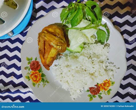 Pecel Ayam Or Fried Chicken Served With Rice Tomato Sauce And Mix