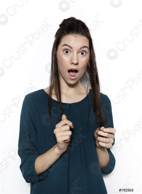 Portrait Of Surprised Woman With Mouth Open Standing On A Stock Photo