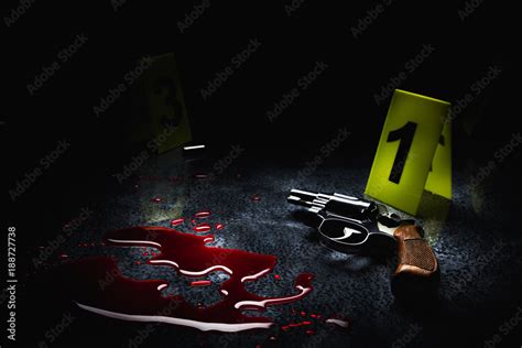 Crime Scene Concept With A Gun On A Blood Puddle With Evidence Markers
