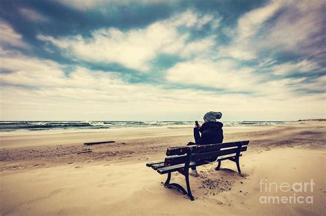 Woman Sitting On A Bench On The Beach Using Her Phone Photograph By Michal Bednarek Fine Art