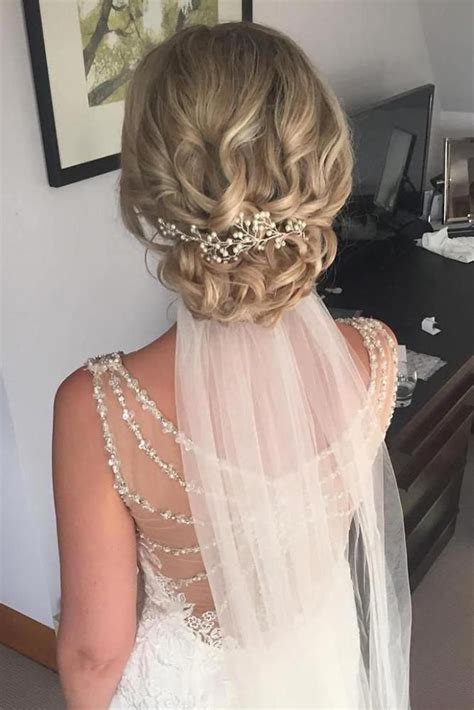 Wedding Hairstyles With Veil On Blonde Bridal Hair With Low Curly Updo