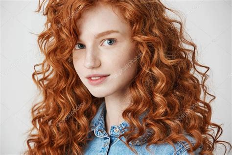 Portrait Of Pretty Redhead Girl Smiling Looking At Camera Over White