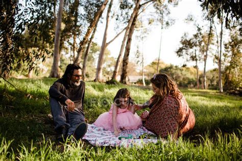 Aunt Uncle And Niece Having Picnic In Field — Flare Imagine Stock
