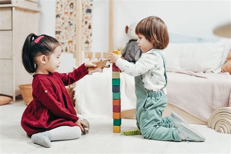 Two Children Playing With Lego Blocks On Floor · Free Stock Photo