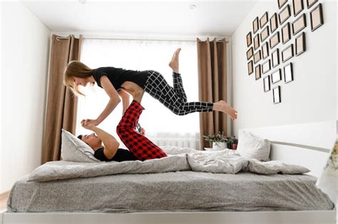 Premium Photo Happy Young Couple Having Fun On The Bed In Pajama Clothes