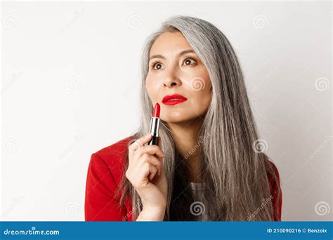 Beauty And Makeup Concept Sensual Mature Asian Female With Grey Hair Looking Aside And Showing