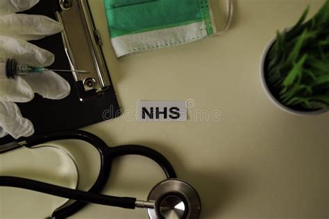 Nhs With Inspiration And Healthcare Medical Concept On Desk Background