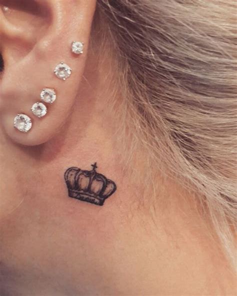 The little cross is drawn in black ink behind the ear and looks so lovely especially with glamorous earrings worn on the lobes. crown tattoo behind ear | Trendy tattoos, Tattoos, Small ...