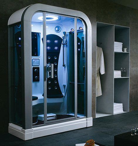 A Bathroom With A Steam Shower In The Middle And Towels On The Shelves
