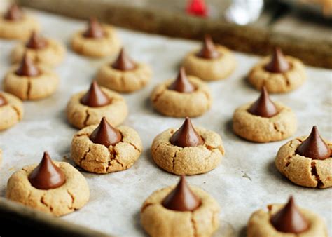This recipe for peanut butter cookies topped with chocolate kiss candies is deliciously simple, fast, and easy! Peanut Butter Kiss Cookies | Holiday Cookies