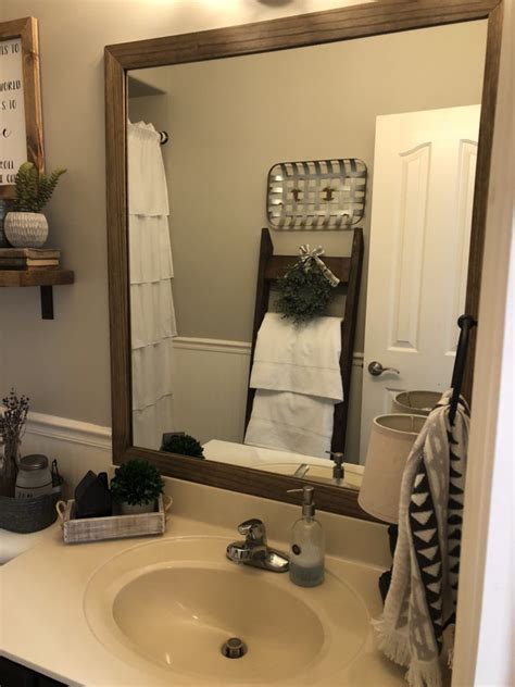 I had thought about doing wood trim but, that didn't tickle my fancy either. Framing out your mirror…the cheap and easy DIY way!