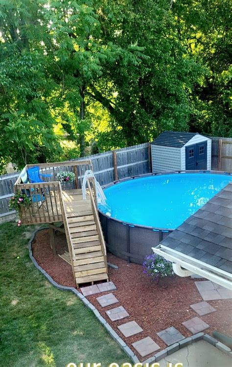 An Above Ground Pool With Steps Leading Up To It And A Slide In The Middle