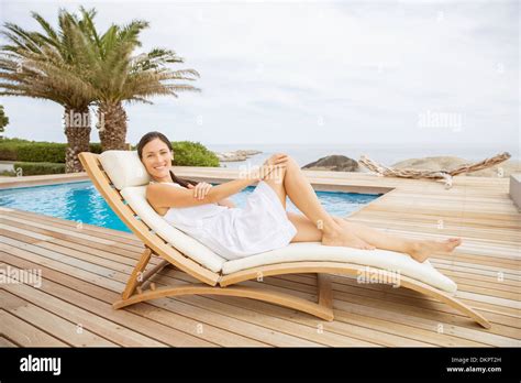 Woman Relaxing In Lounge Chair At Poolside Stock Photo 63811401 Alamy