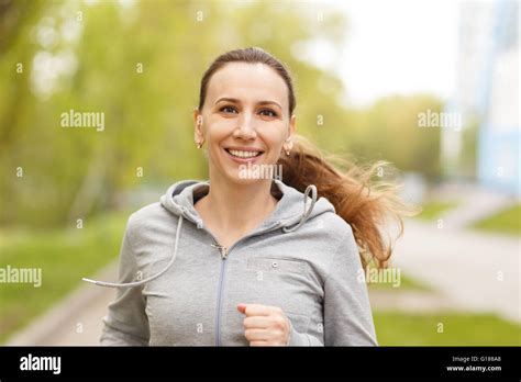 Young Smiling Woman Jogging In Park In The Morning Beautiful Caucasian
