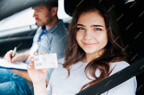 Premium Photo Young Woman Showing Driver Licence