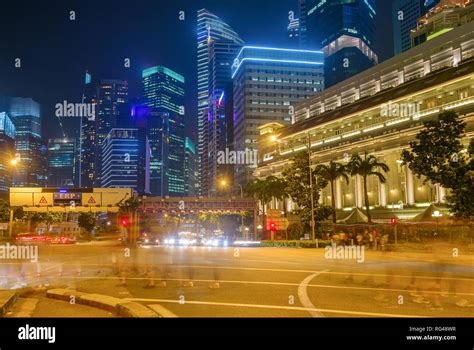Singapore Metropolis Downtown Core Illuminated In Night Crowd Of