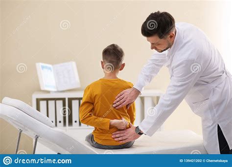 Chiropractor Examining Child With Back Pain Stock Photo Image Of