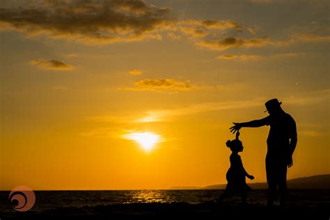 Father And Daughter Silhouettes Dancing In This Beautiful Sunset At