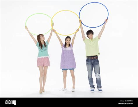 Young Man And Women Holding Hula Hoops Stock Photo Alamy