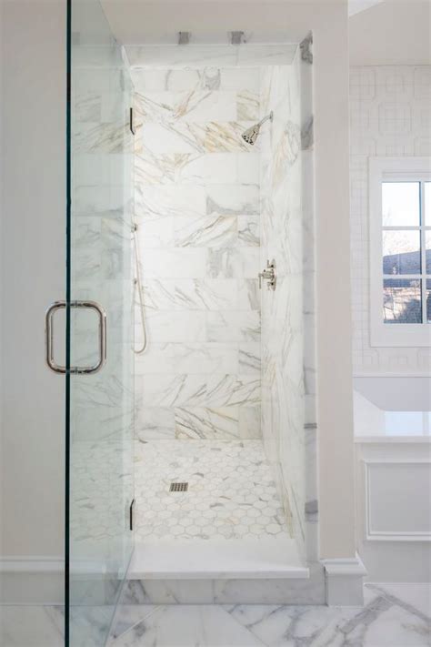 This welcoming all white shower uses marble and chrome fixtures to bring about modern design. White Marble Walk-In Shower | HGTV