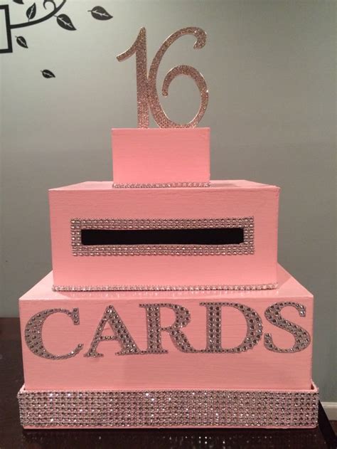 A Pink Cake That Has The Number Sixteen On It And Is Decorated With Silver Glitter