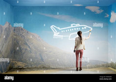 Young Woman Traveller Drawing Airplane On Wall Stock Photo Alamy