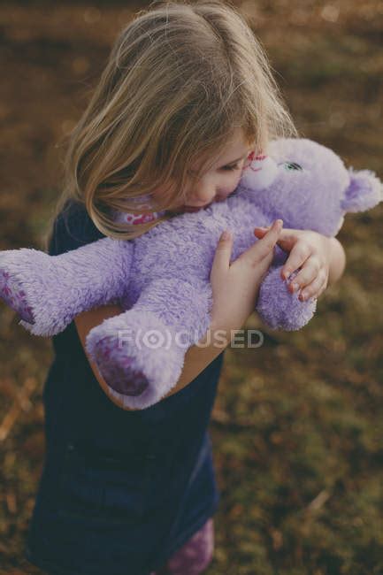 Girl Cuddling Teddy Bear — Carrying Portrait Stock Photo 164884758
