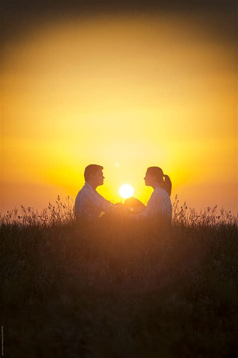 Romantic Couple Sitting Setting Sun Del Colaborador De Stocksy Lee