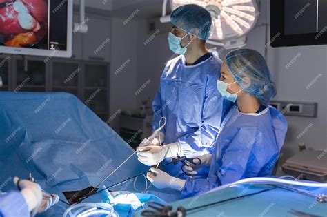 Premium Photo The Surgeons Holing The Instrument In Abdomen Of