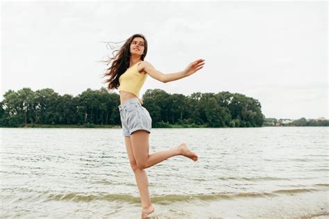Premium Photo Slim Woman Legs Walking Barefoot Along The River Female Feet On Sea Beach With