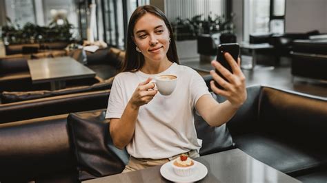 Premium Photo Young Woman Taking A Selfie At The Coffee Shop