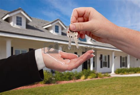 Handing Over The House Keys In Front Of New Home Royalty Free Stock