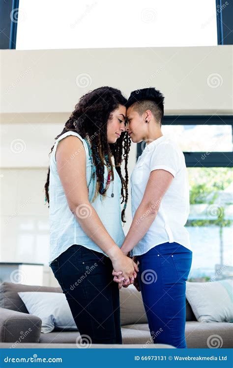 Romantic Lesbian Couple Standing Face To Face And Holding Hands Stock Image Image Of Apartment