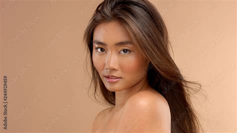 profile portrait of asian japanese thai model watching to the camera natural asian makeup wet