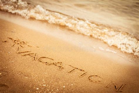 The Word Vacation Written In The Sand On A Beach Stock Photo Image Of